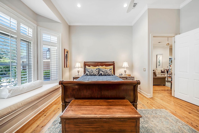 bedroom with light hardwood / wood-style floors and crown molding