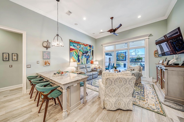 interior space with ceiling fan with notable chandelier, light wood-type flooring, and crown molding