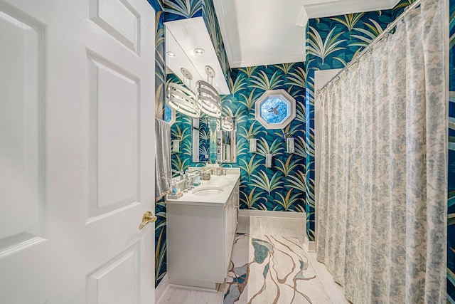 bathroom with crown molding and vanity