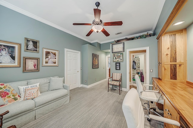 home office featuring crown molding, ceiling fan, and light colored carpet