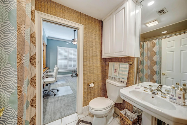 bathroom with sink, tile patterned flooring, crown molding, and toilet