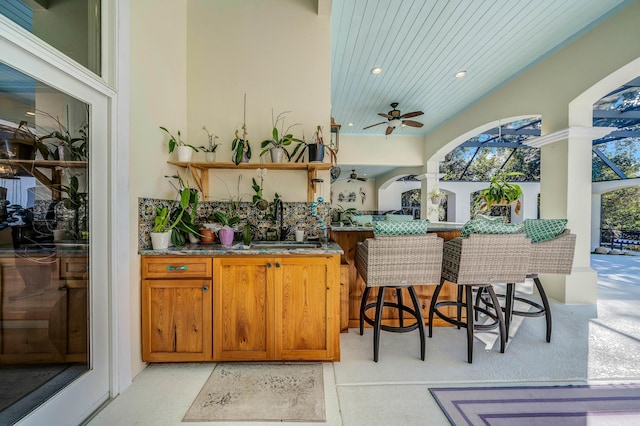 view of patio featuring ceiling fan and sink