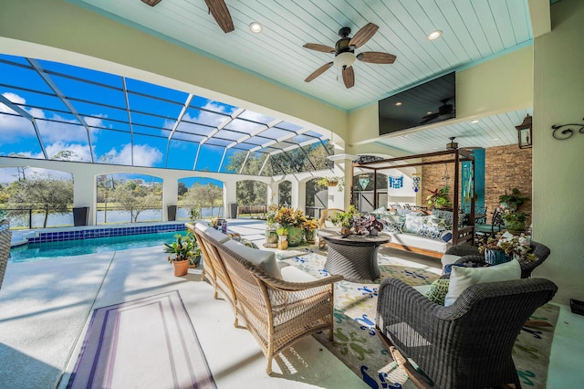 sunroom / solarium with ceiling fan, a swimming pool, and wood ceiling