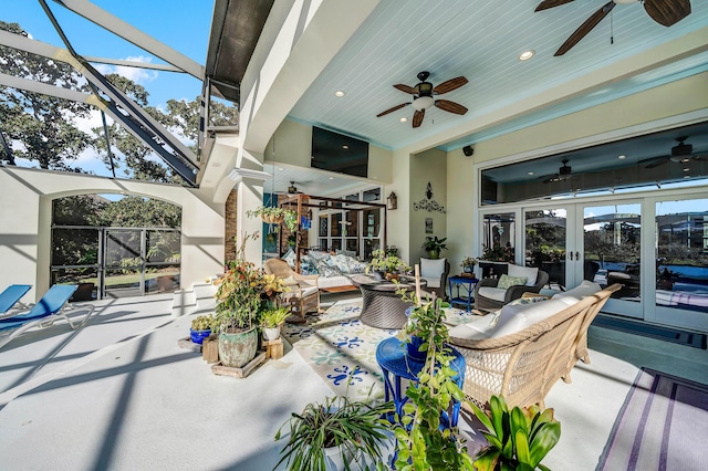 view of patio featuring french doors, an outdoor hangout area, ceiling fan, and a lanai