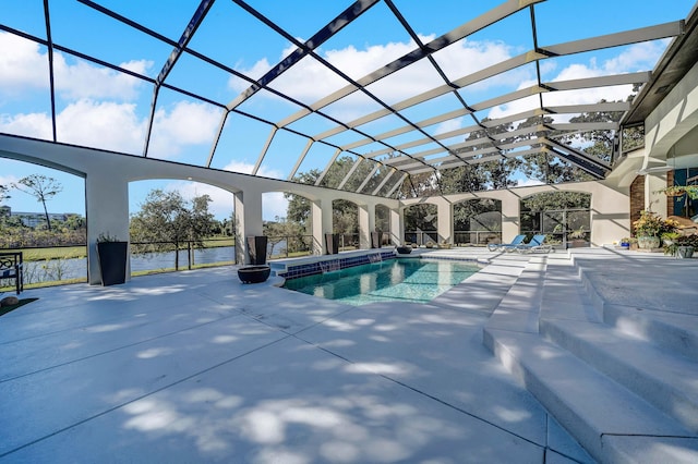 view of swimming pool with a patio area, a lanai, and a water view