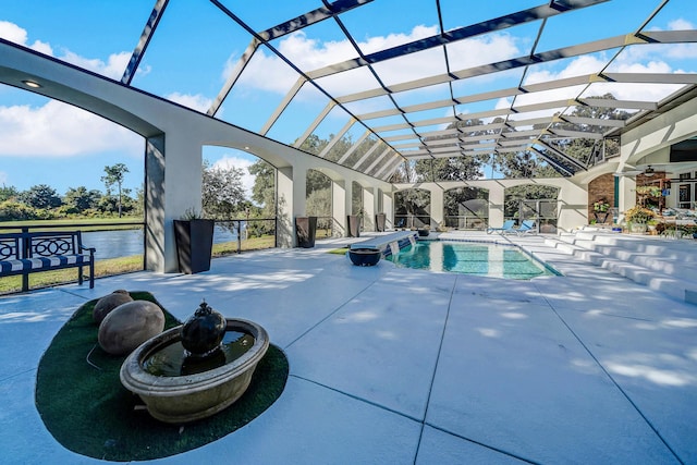 view of swimming pool with a patio, a water view, and glass enclosure