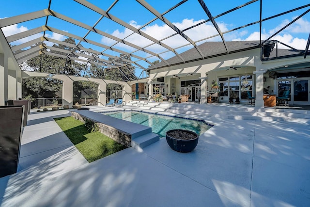 view of swimming pool featuring a patio area, ceiling fan, and a lanai