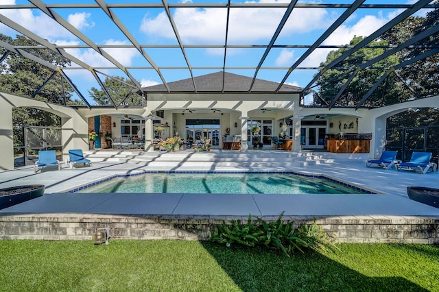 view of pool with french doors, a patio, glass enclosure, and ceiling fan