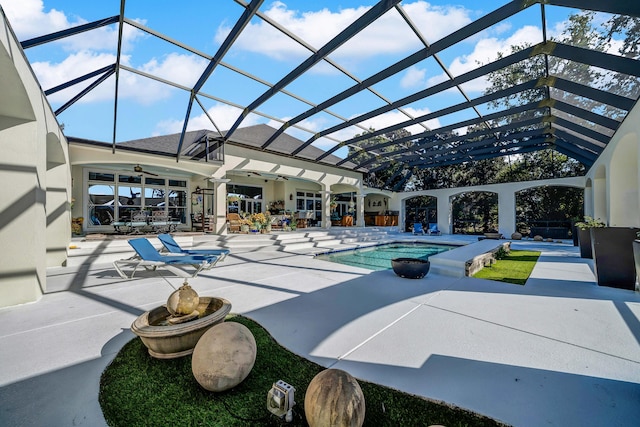 view of swimming pool featuring ceiling fan, a patio, and glass enclosure