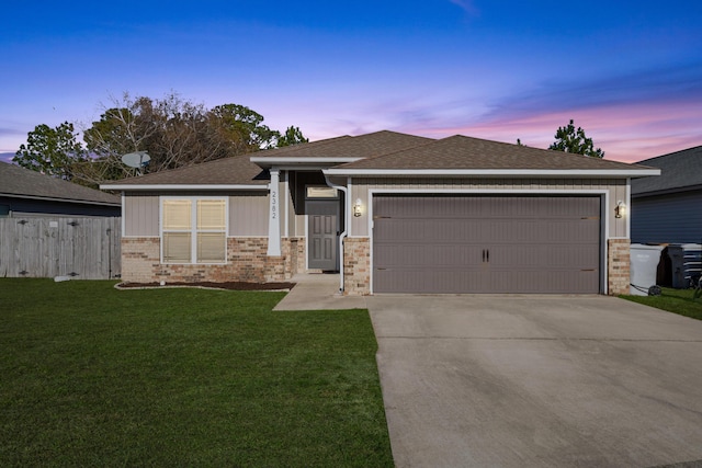 view of front of home with a yard and a garage