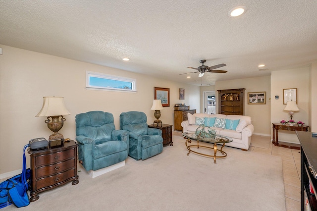 tiled living room featuring a textured ceiling and ceiling fan