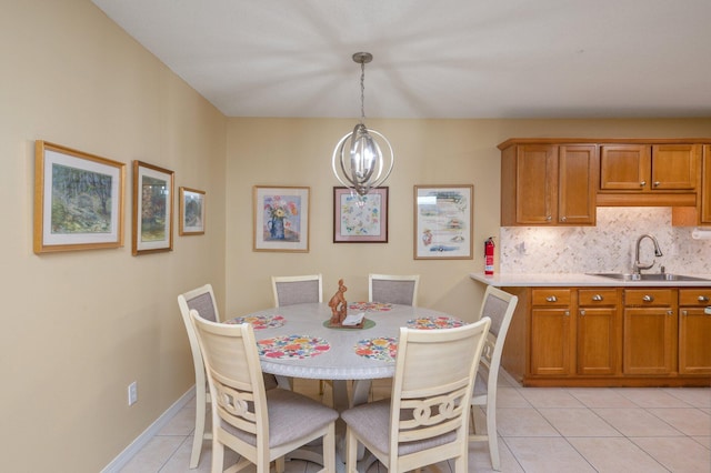 dining area with a chandelier, light tile patterned floors, and sink