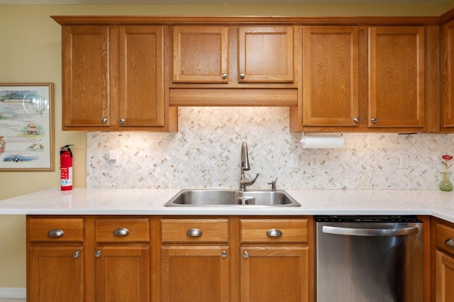 kitchen featuring dishwasher, backsplash, and sink