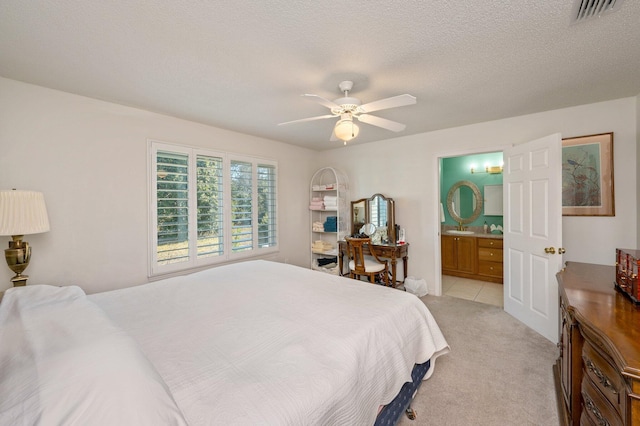 carpeted bedroom featuring ceiling fan, a textured ceiling, and connected bathroom