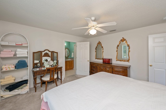 carpeted bedroom featuring ceiling fan, a textured ceiling, and connected bathroom