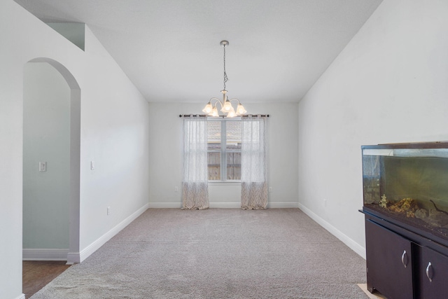 dining area featuring carpet and a notable chandelier