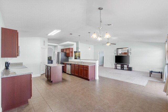 kitchen featuring sink, stainless steel appliances, pendant lighting, a kitchen island, and ceiling fan with notable chandelier