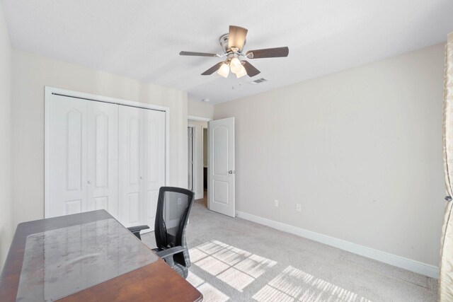 carpeted home office with ceiling fan