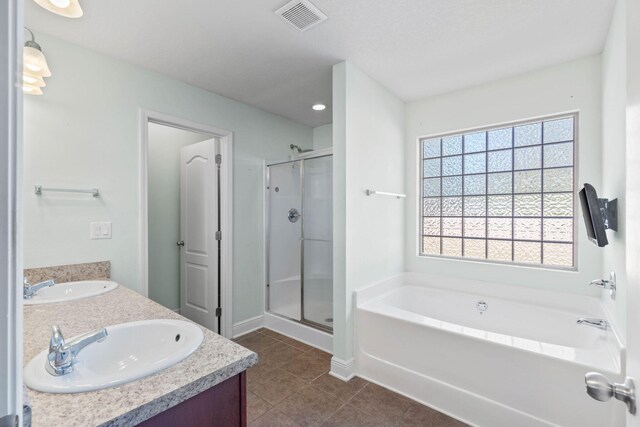 bathroom featuring separate shower and tub, tile patterned flooring, and vanity