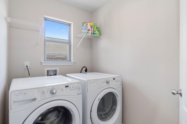 washroom with washing machine and clothes dryer