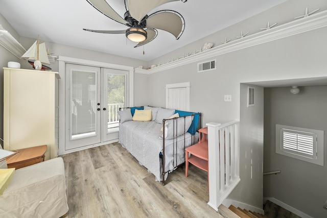 bedroom with access to exterior, french doors, light wood-type flooring, ceiling fan, and crown molding