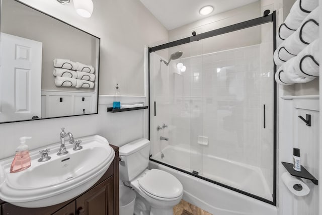 full bathroom with toilet, combined bath / shower with glass door, and vanity