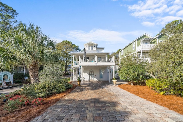 view of front of house featuring a balcony and a carport