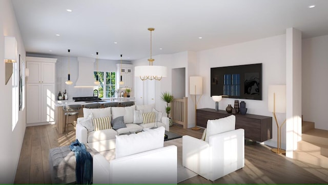 living room featuring sink, a chandelier, and wood-type flooring