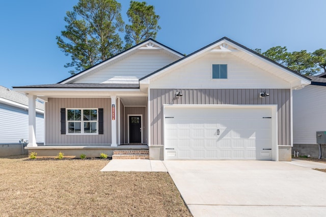 view of front of property with an attached garage, covered porch, driveway, and board and batten siding