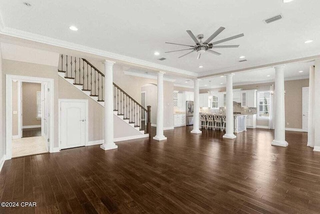 unfurnished living room with ceiling fan, dark wood-type flooring, and ornamental molding