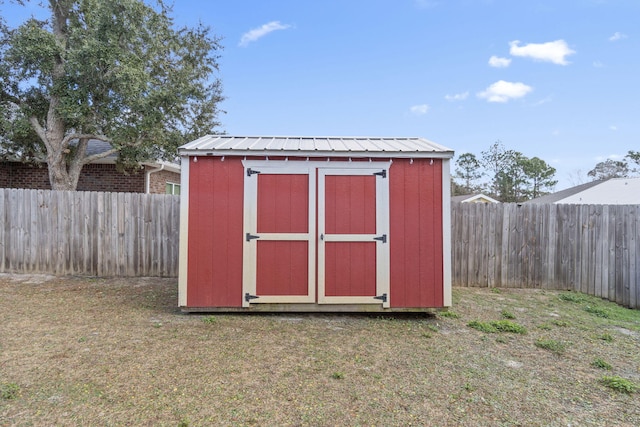 view of outbuilding with a yard