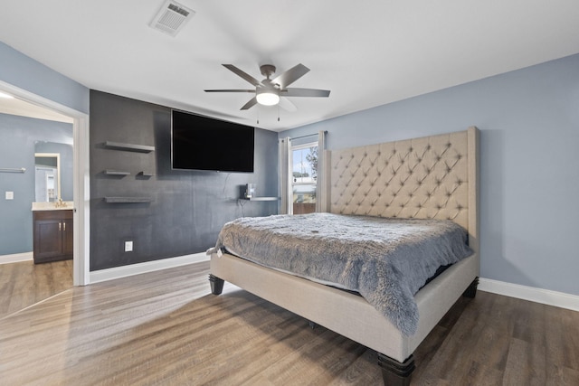 bedroom with hardwood / wood-style flooring, ceiling fan, and ensuite bathroom