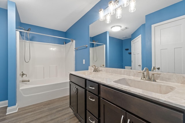 bathroom featuring vanity, wood-type flooring, and  shower combination