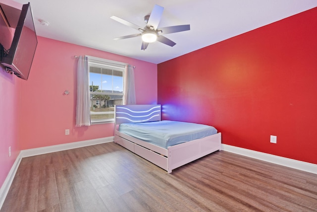 bedroom featuring hardwood / wood-style floors and ceiling fan