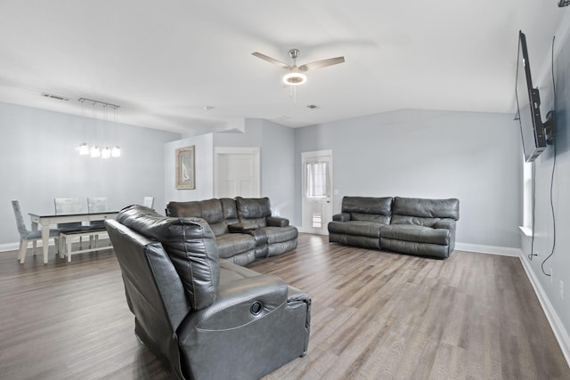 living room with ceiling fan, lofted ceiling, and hardwood / wood-style flooring