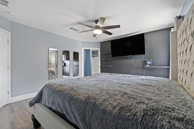 bedroom with ceiling fan and wood-type flooring