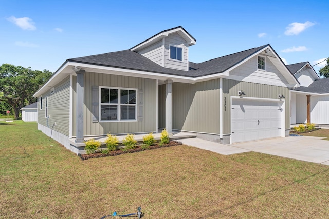 view of front of home featuring a garage and a front lawn