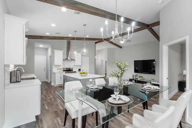 dining space with lofted ceiling with beams, dark hardwood / wood-style floors, a chandelier, and sink