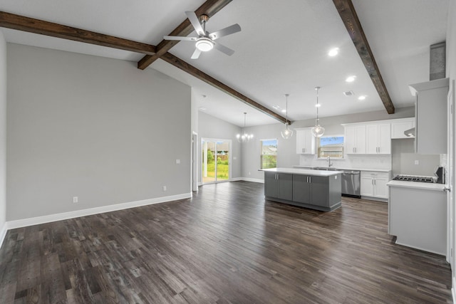 kitchen with pendant lighting, white cabinetry, a center island, lofted ceiling with beams, and stainless steel dishwasher