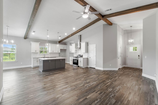 unfurnished living room with sink, dark hardwood / wood-style flooring, ceiling fan with notable chandelier, and vaulted ceiling with beams