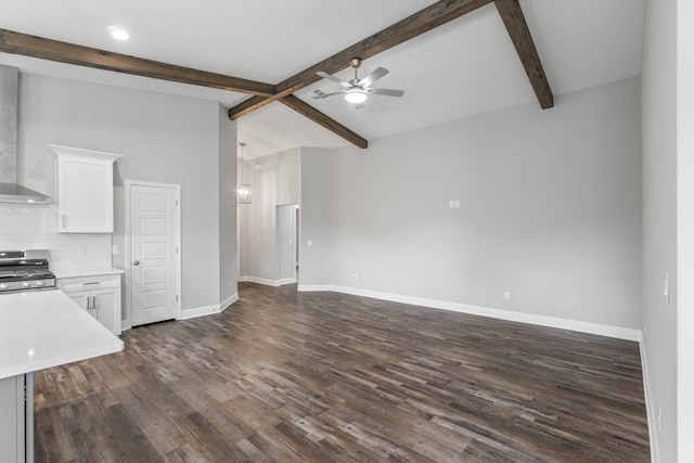 kitchen featuring white cabinetry, vaulted ceiling with beams, tasteful backsplash, stainless steel range oven, and dark hardwood / wood-style flooring