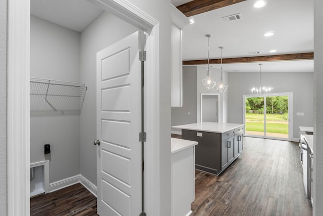 kitchen featuring gray cabinets, a kitchen island, pendant lighting, vaulted ceiling with beams, and dark wood-type flooring