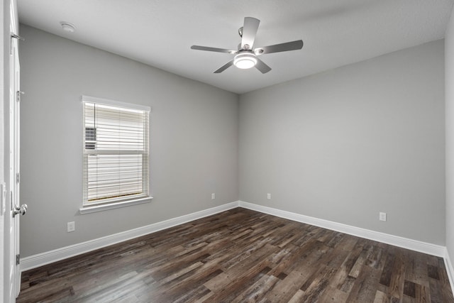 empty room featuring dark hardwood / wood-style flooring, lofted ceiling, and ceiling fan