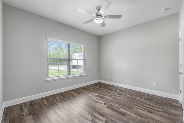 unfurnished room with ceiling fan and dark hardwood / wood-style flooring