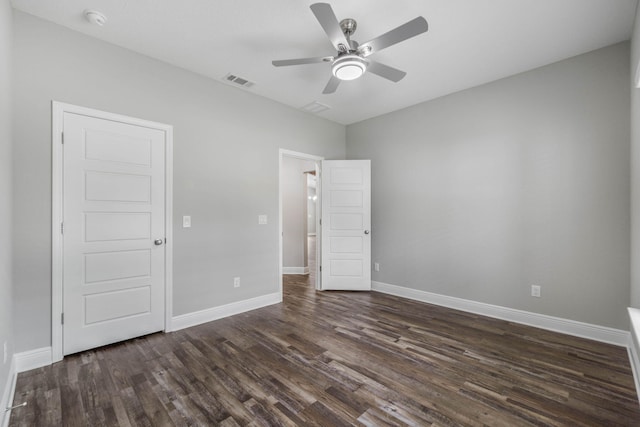 unfurnished bedroom featuring ceiling fan and dark hardwood / wood-style flooring