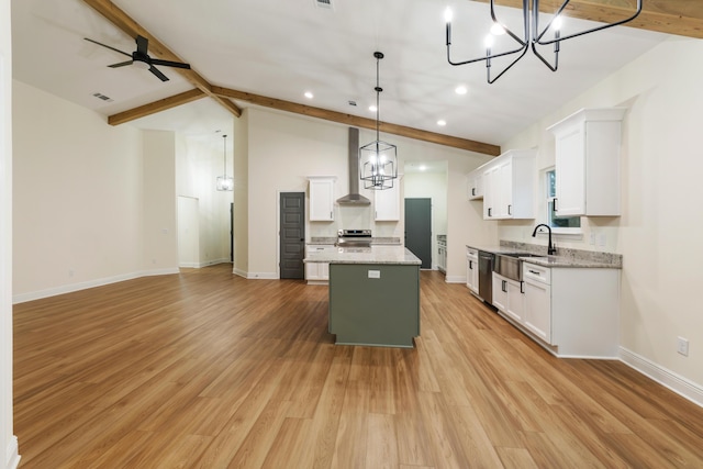 kitchen with vaulted ceiling with beams, a kitchen island, appliances with stainless steel finishes, and white cabinets