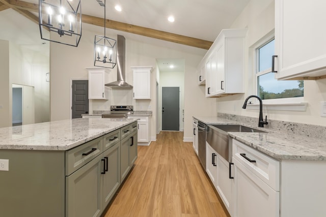 kitchen with a center island, stainless steel appliances, light wood-style flooring, white cabinetry, and wall chimney exhaust hood