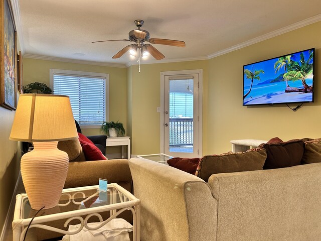 living room with ceiling fan and crown molding