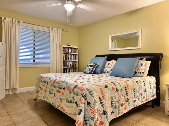 tiled bedroom featuring ceiling fan