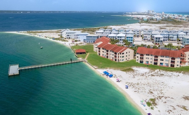 drone / aerial view with a water view and a beach view